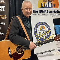 Fred Bartenstein and the 2023 Strings for Dreams Bluegrass Raffle prize guitar at World of Bluegrass, Raleigh, NC, September 30, 2022. (Photo: Nancy Cardwell)
