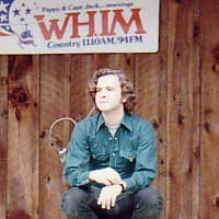 Emcee Fred Bartenstein waits for a late band onstage at the
Country Gentlemen's Bluegrass Festival, Escoheag, RI. 1973 (Photo: Cole
Denoncourt)