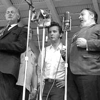 Kenny Baker, Rual Yarbrough, Bill Monroe, Curtis Blackwell, Fred, Mac Wiseman, James Monroe. Watermelon Park, Berryville, VA. July, 1969 (Photo: Artie Rose)