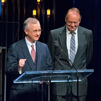 Fred Bartenstein and Gary Reid, co-authors of The Bluegrass Hall of Fame: Inductee Biographies 1991-2014, present Neil Rosenberg's Hall of Fame induction at IBMA Awards Show, World of Bluegrass, Raleigh, NC, October 2, 2014. (Photo: Daniel Boner)