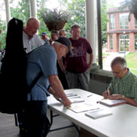 Fred Bartenstein signs copies of The Bluegrass Hall of Fame at Augusta Heritage Center’s Bluegrass Week, Elkins, WV, July, 2015. (Photo: Donald Wermuth)